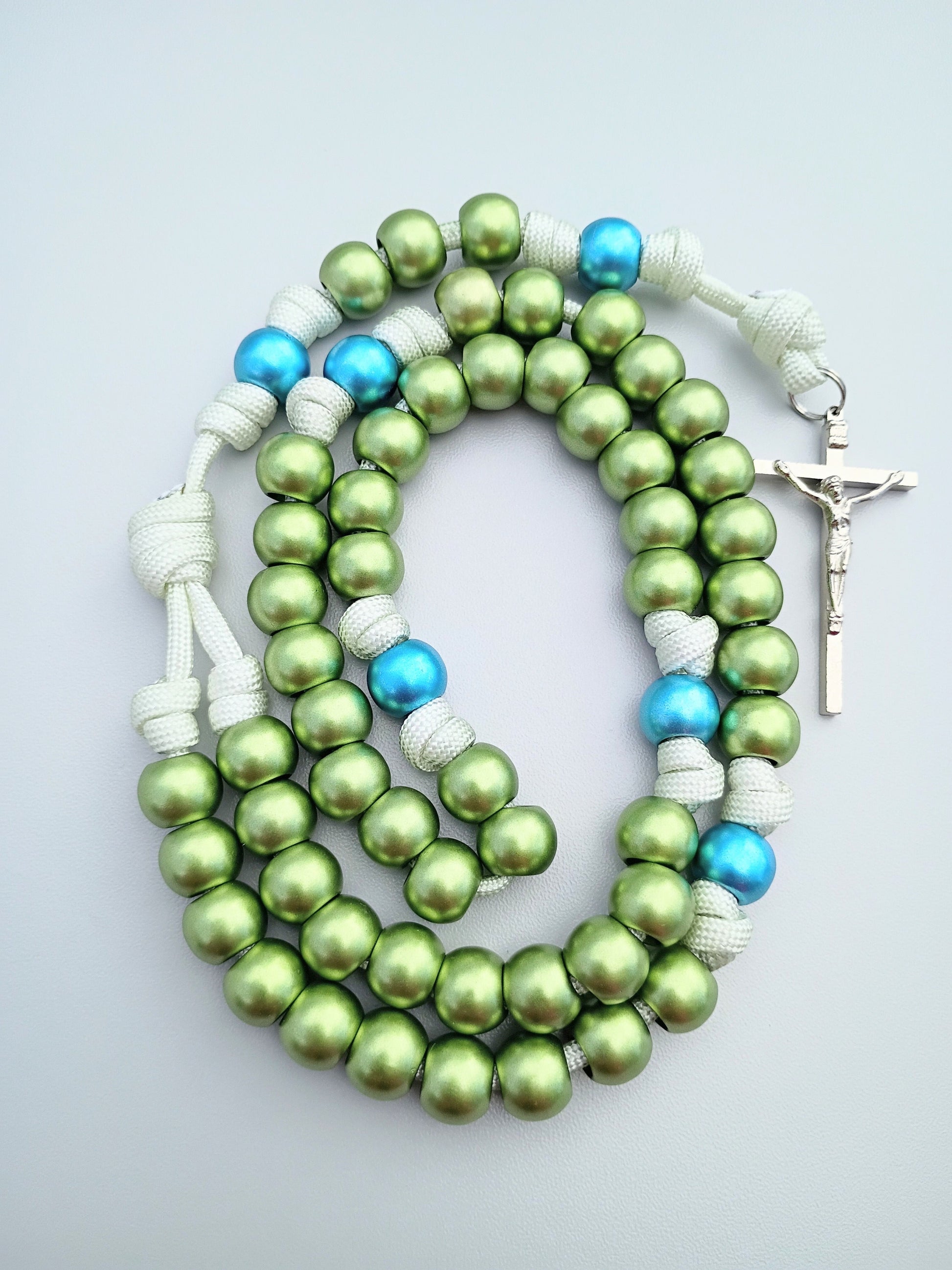 Rosary with shiny green and blue beads with a silver crucifix.