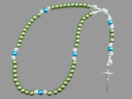 Green and blue paracord rosary with a crucifix on a light gray background